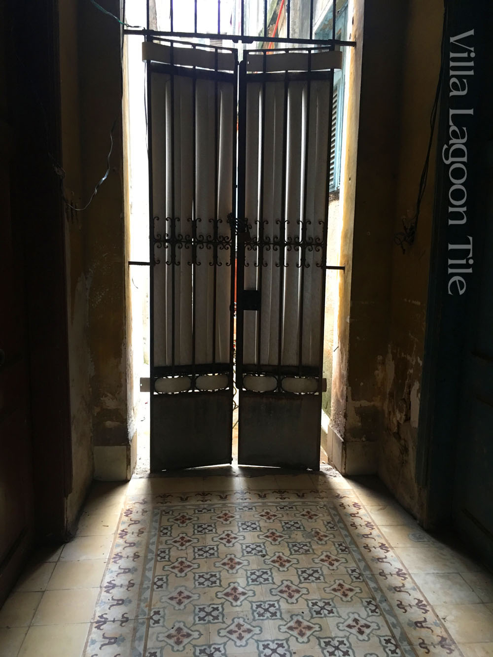 Hallway cement tile  in Havana, Cuba. This tile has the popular colors of pink and cranberry. 