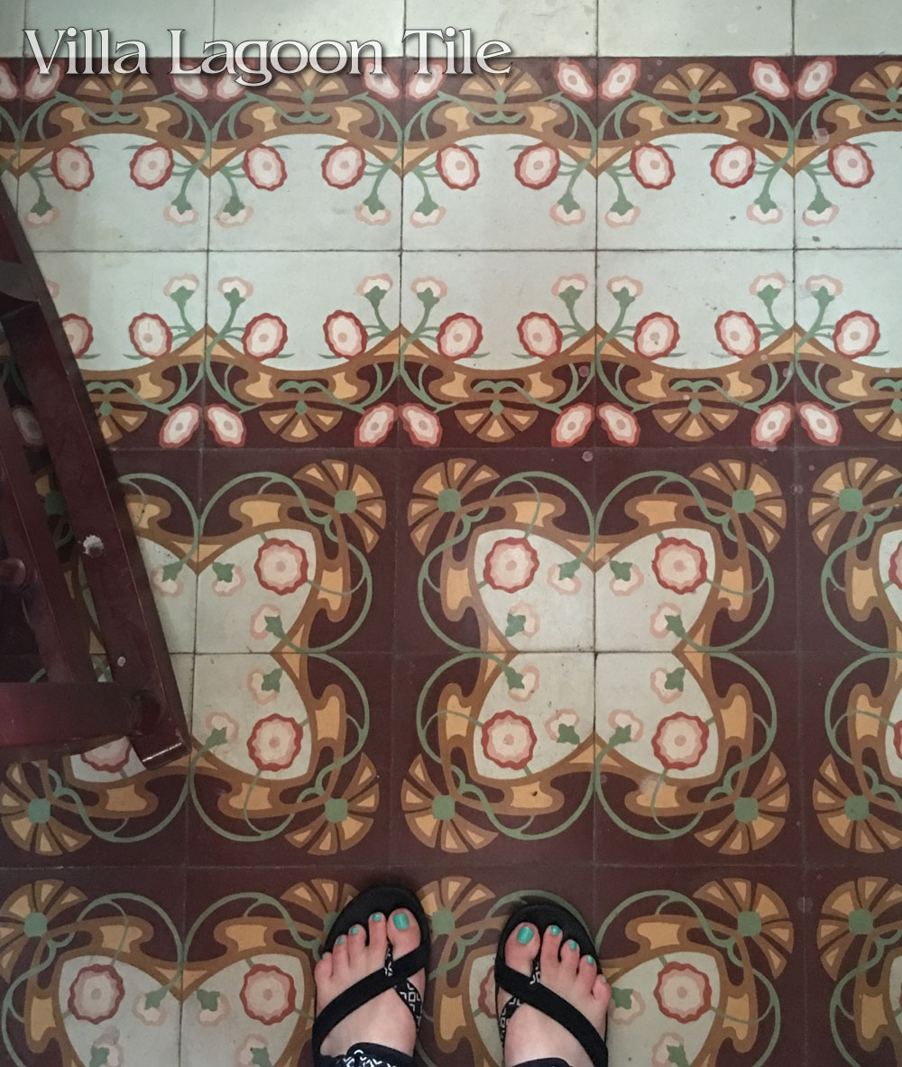 Art Nouveau styled floral floor of cement tile in Havana with a double border. 